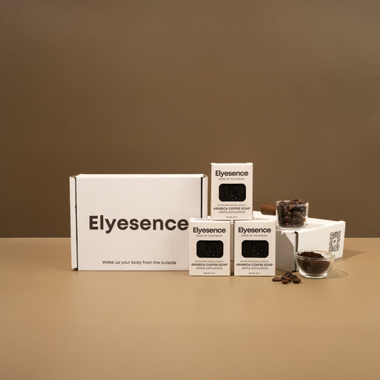 Elyesence Coffee Glow box set with three Arabica Coffee Soap bars displayed next to coffee beans and glass jars.