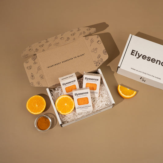 Orange Glow box open with sliced oranges and turmeric powder on brown background