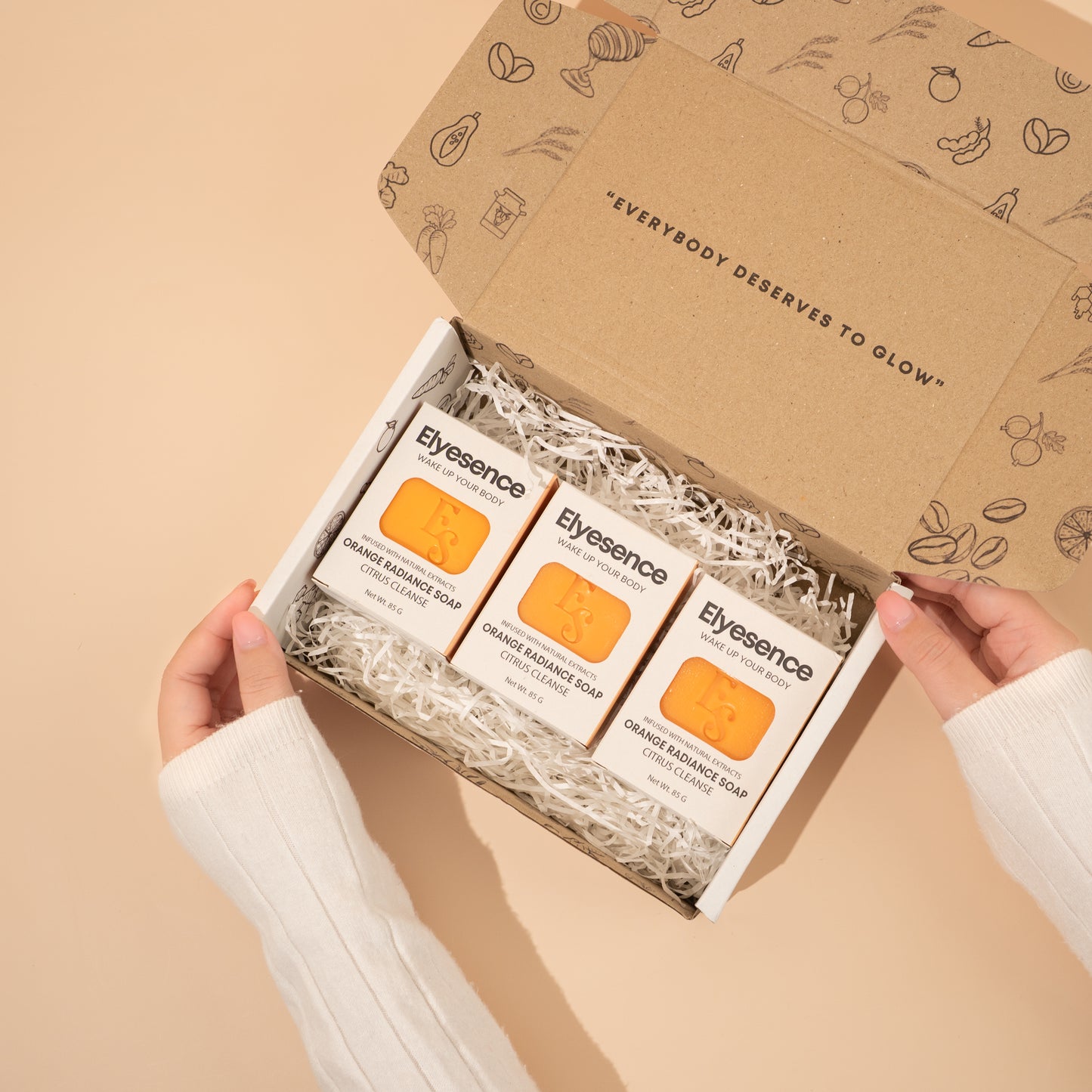 Open Elyesence Orange Glow box with 3 Orange Radiance Soap bars in shredded packaging